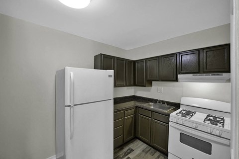 a kitchen with white appliances and black cabinets